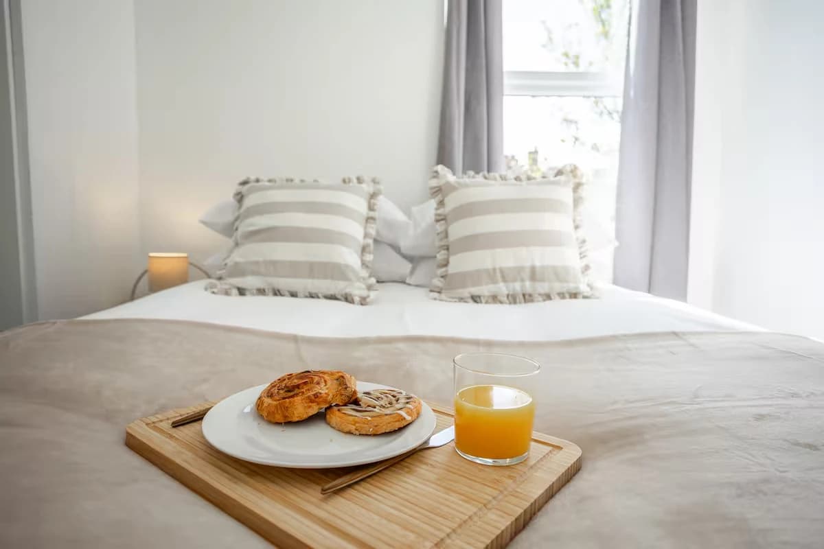Double bed with a breakfast tray at Algernon Road, Melton Mowbray