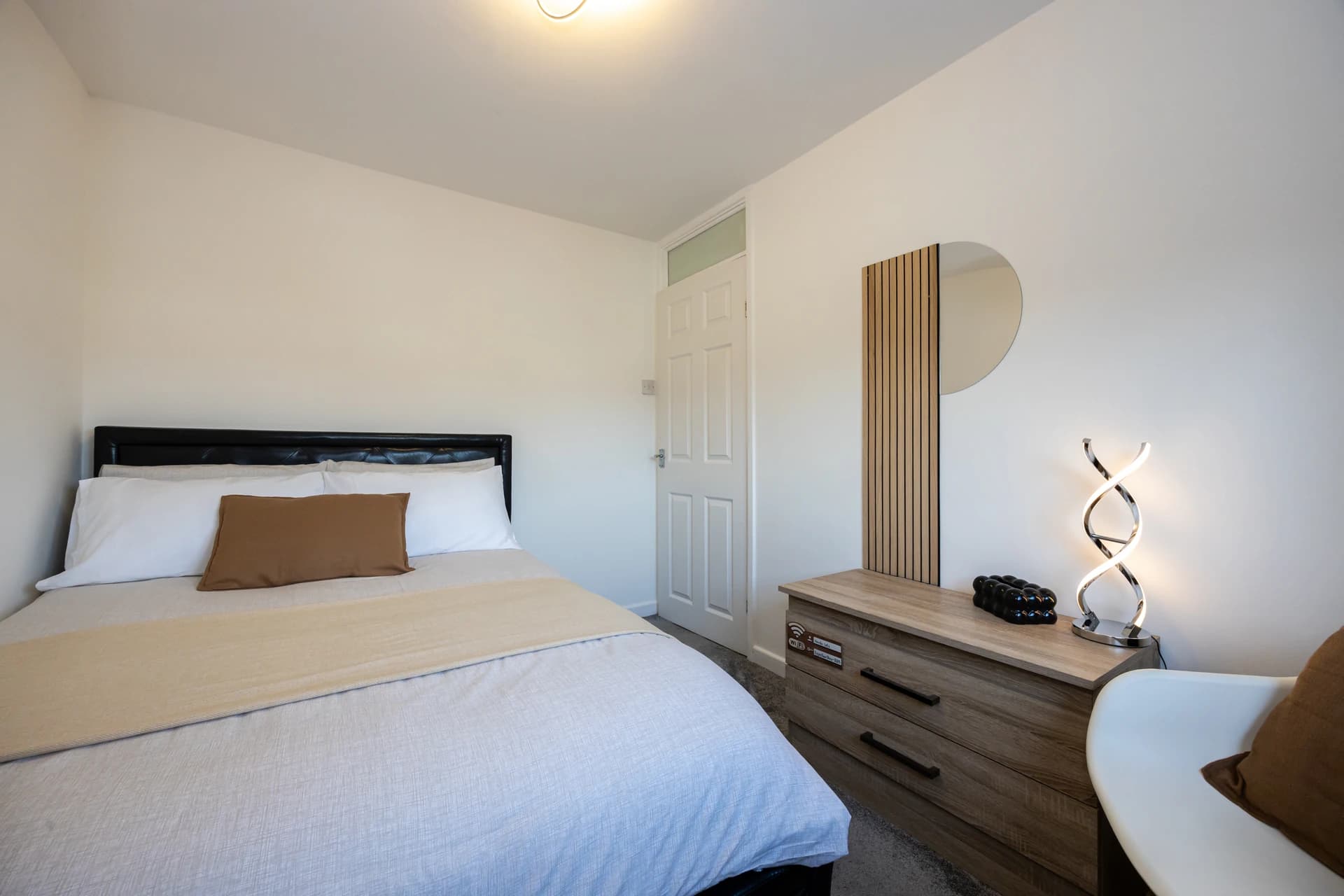 Double bedroom with bedside table at Amberwood Drive, Wythenshawe