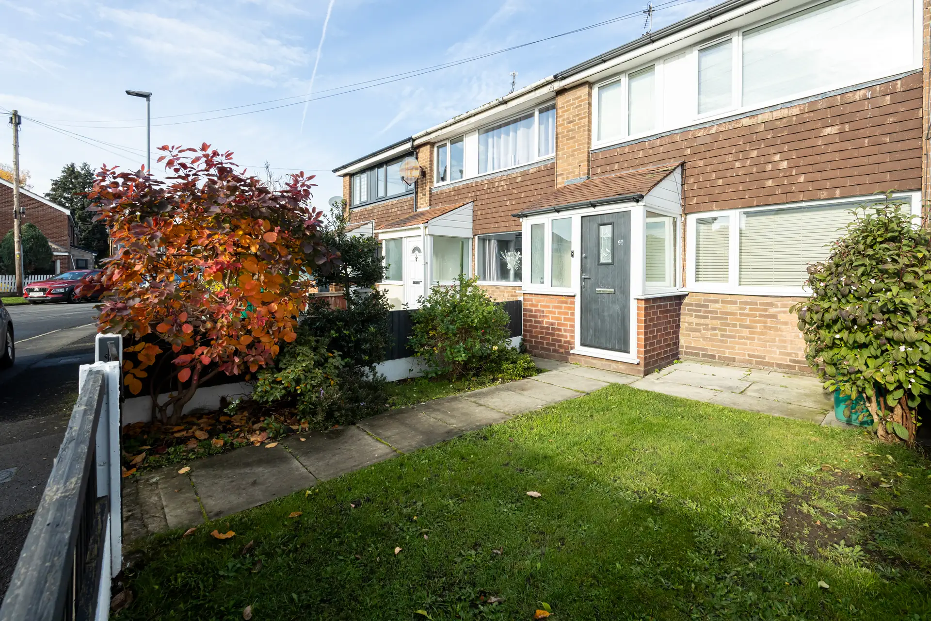 Front of the house on Amberwood Drive, Wythenshawe, with lawn and on-street parking