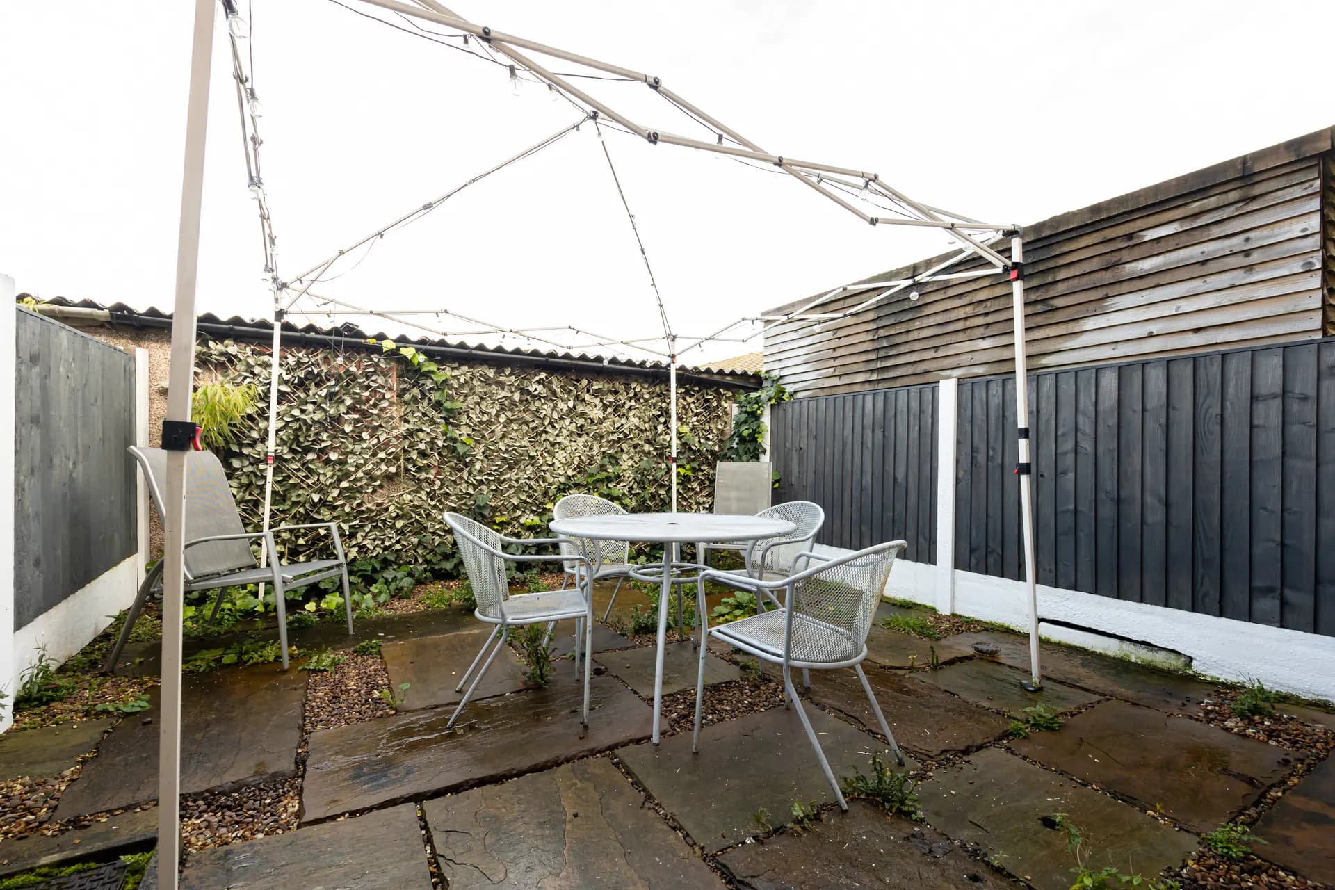 Private back garden with gazebo and outdoor seating at Amberwood Drive, Wythenshawe