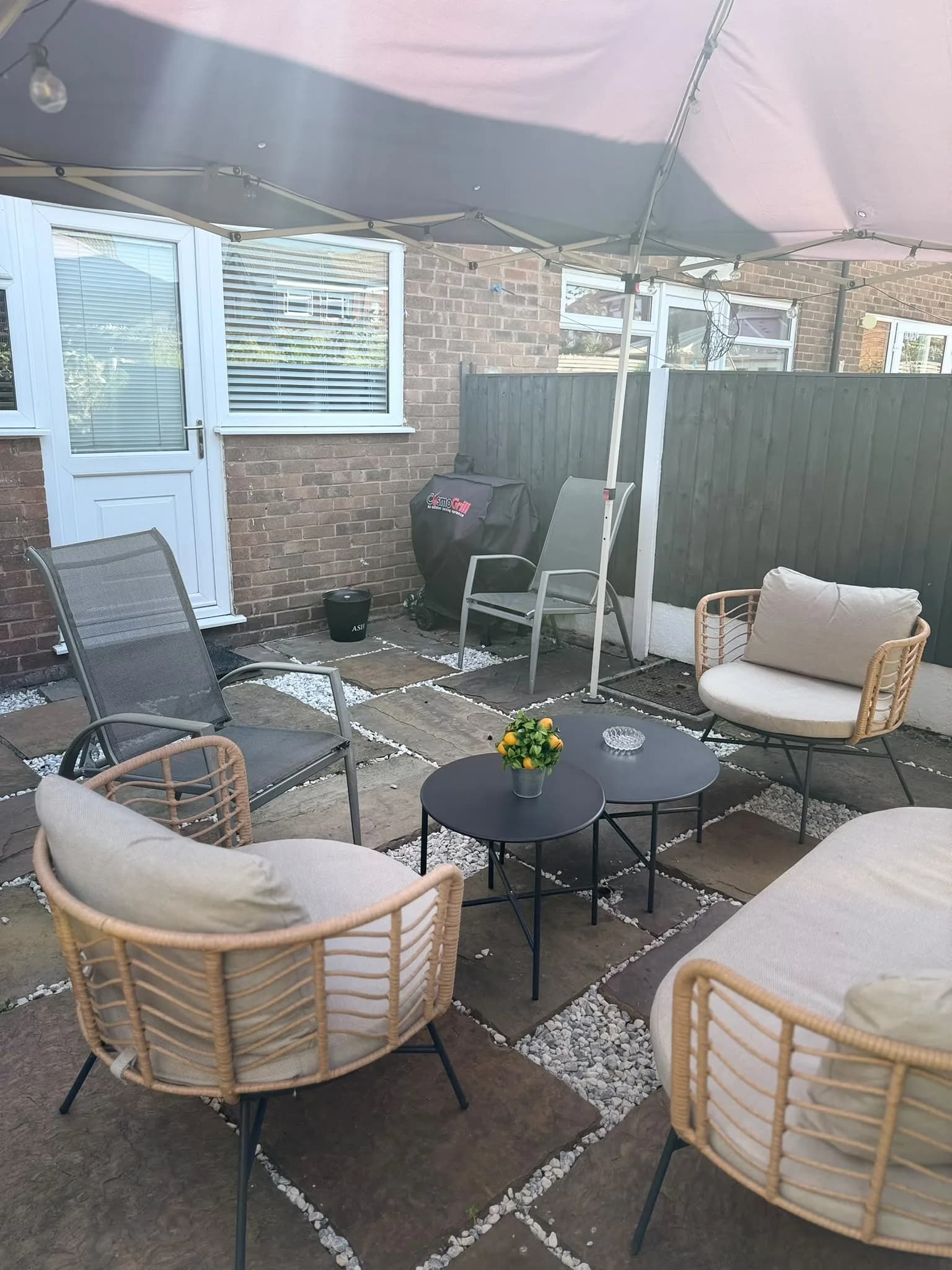 Private back garden patio at Amberwood Drive, Wythenshawe, with outdoor seating, gazebo and BBQ