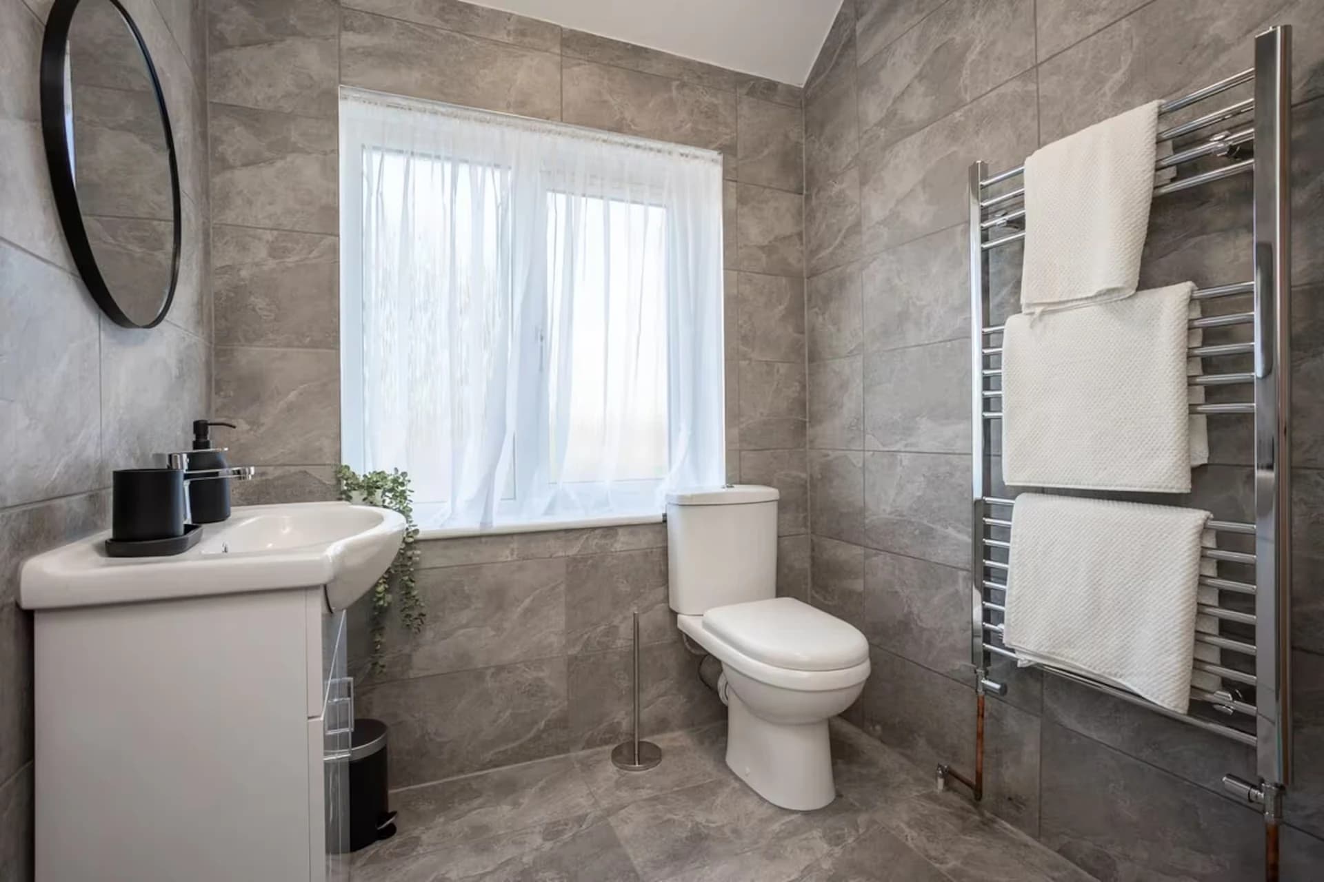 Bathroom with heated towel rail and window at Doctor's Lane, Melton Mowbray