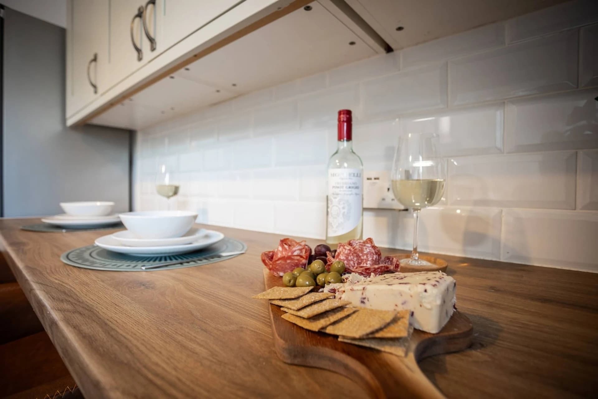 Dining table with cheese board and wine at Doctor's Lane, Melton Mowbray
