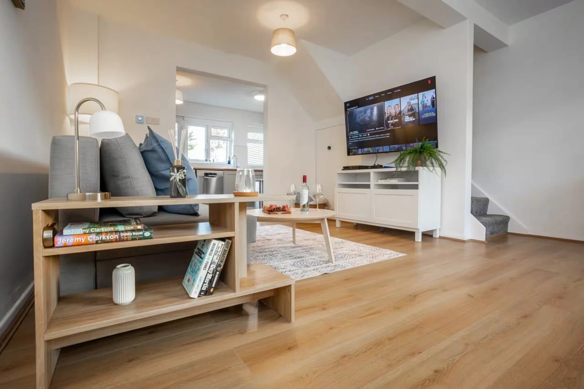 Bright lounge with wooden floors and bookshelf at Doctor's Lane, Melton Mowbray