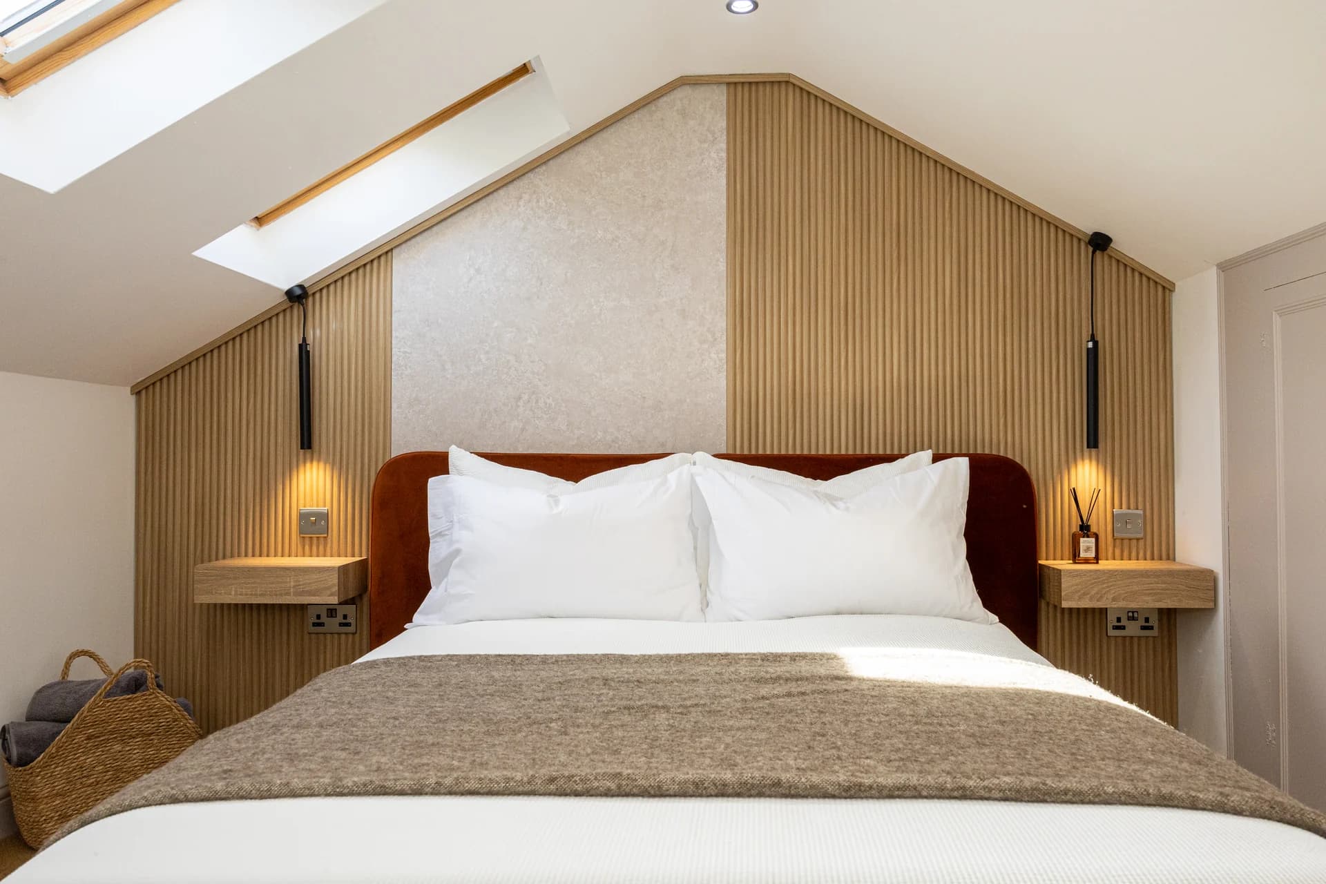 Loft bedroom with double bed and skylights at Meadow Croft, Wythenshawe