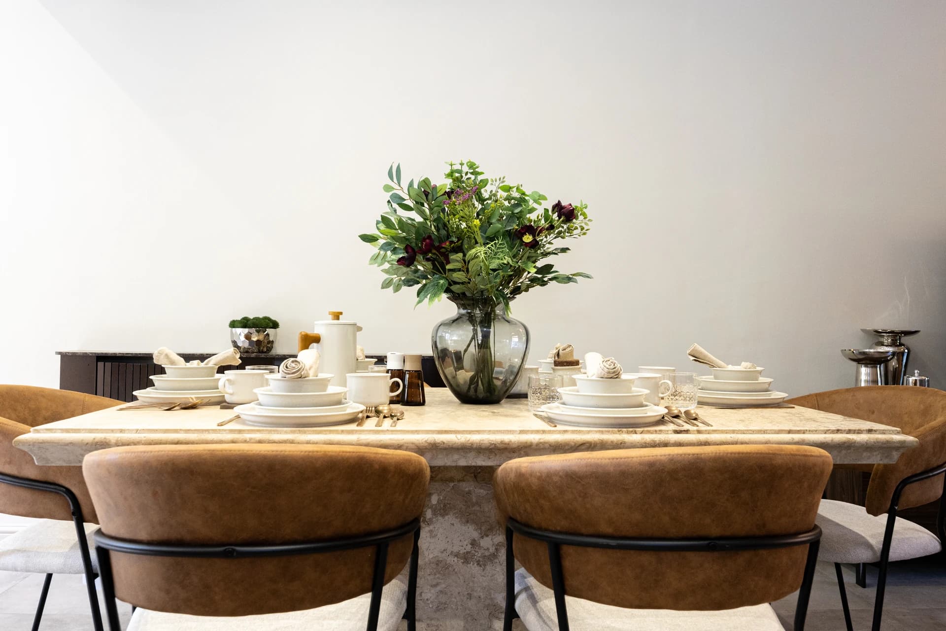 Dining table laid for six guests at Meadow Croft, Wythenshawe