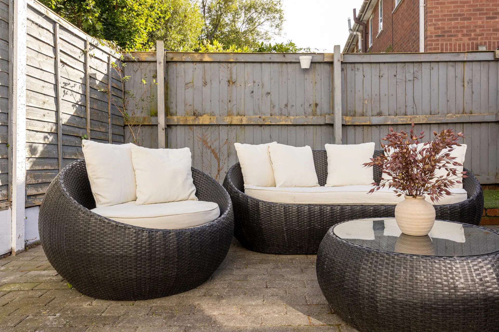 Patio with rattan garden furniture at Meadow Croft, Wythenshawe